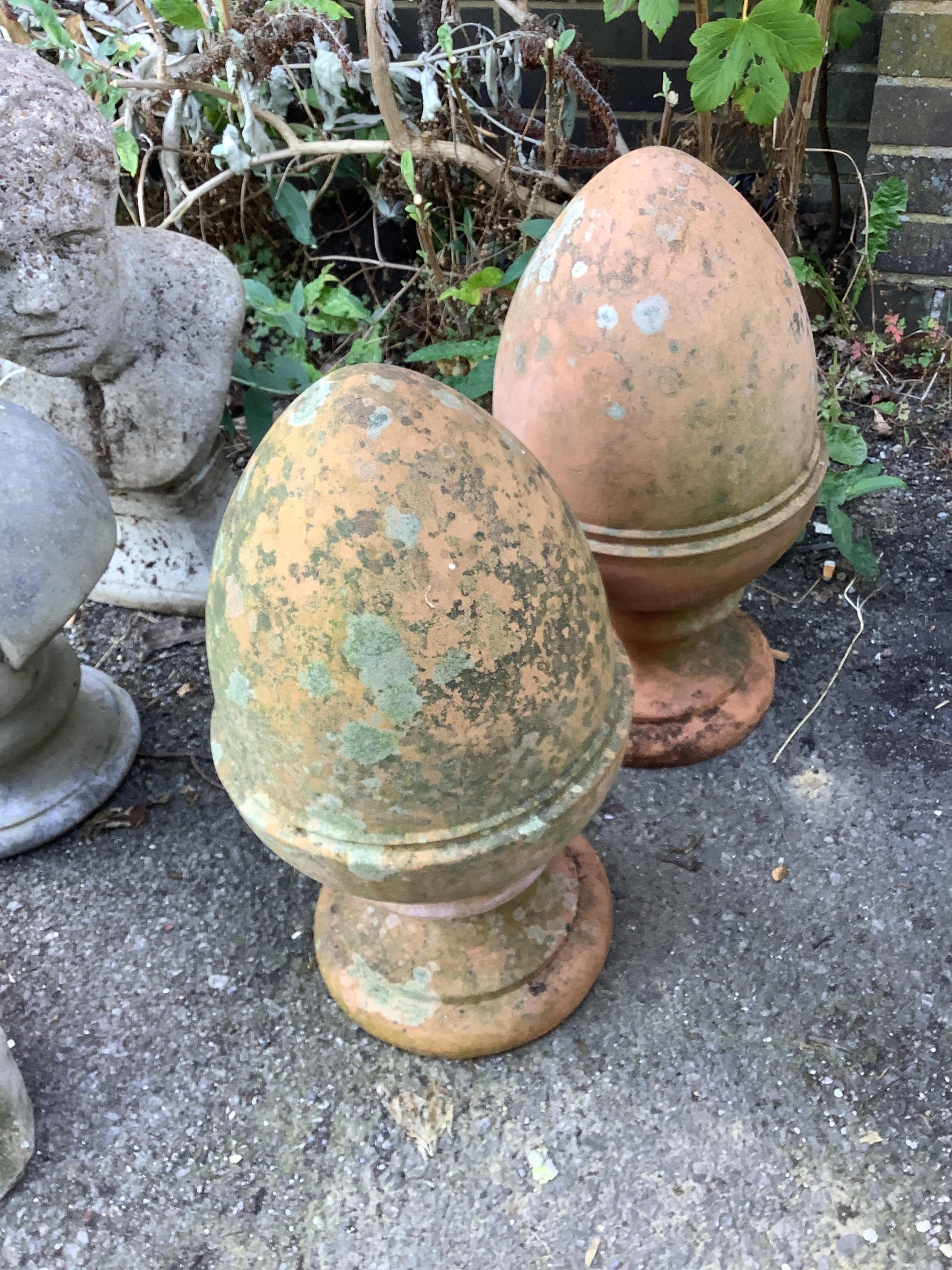 A pair of terracotta acorn garden finials, height 50cm. Condition - fair